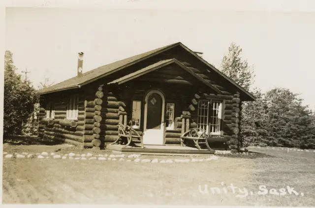 Log cabin with rustic porch chairs